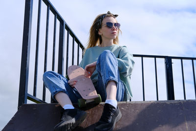 Portrait of young woman sitting on staircase