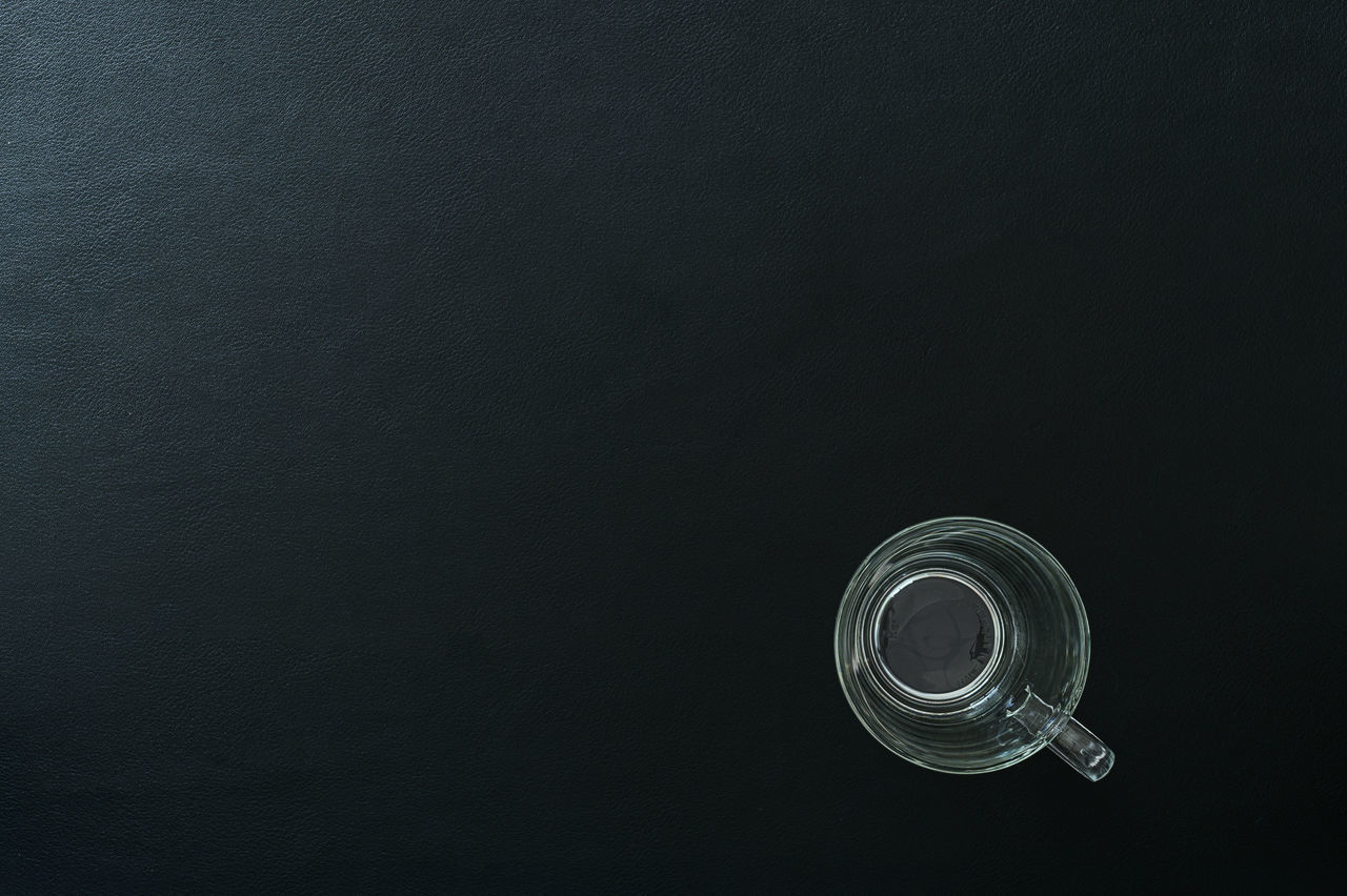 DIRECTLY ABOVE SHOT OF GLASS CANDLE ON TABLE