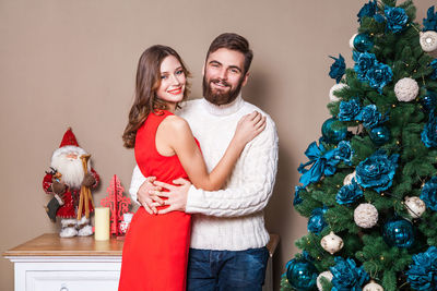 Portrait of young couple in christmas tree