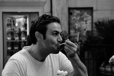 Man eating whipped cream at cafe