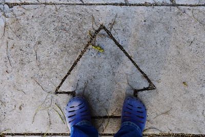 Low section of person standing on footpath