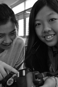 Portrait of a smiling girl sitting on table