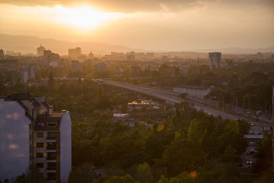 Aerial view of cityscape against sky during sunset