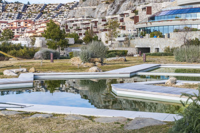 View of swimming pool by buildings in city