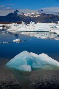 Scenic view of frozen lake against mountain range