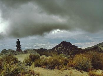 Scenic view of landscape against cloudy sky
