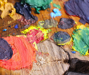 Close-up of colorful paints on wood