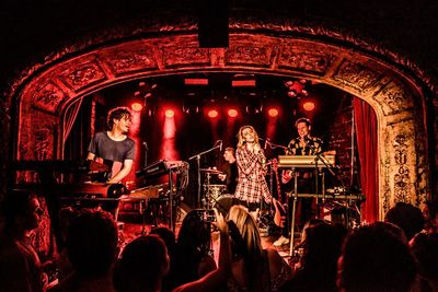 People playing guitar at music concert