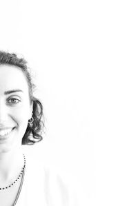 Close-up portrait of a smiling woman over white background