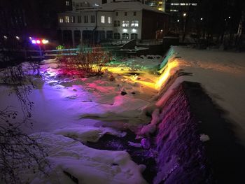 Wet illuminated city at night