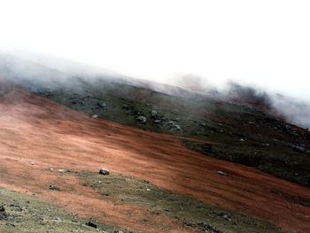 Scenic view of landscape against sky during rainy season