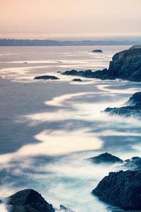 Scenic view of sea against sky at sunset