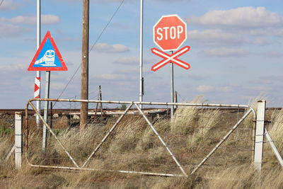 Low angle view of road sign against sky