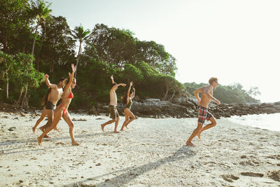 Friends enjoying at beach during summer