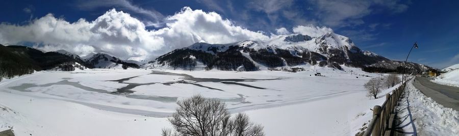 Panoramic view of snowcapped mountains against sky