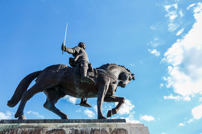 Low angle view of statue against sky