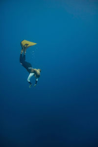 Woman scuba diving in sea