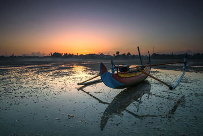 Scenic view of beach against sky during sunset