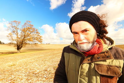 Portrait of man standing on land against sky