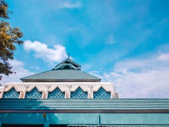 Low angle view of building against cloudy sky