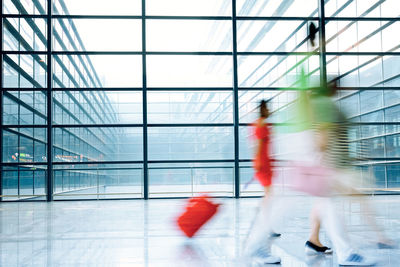 Blurred motion of people walking in airport