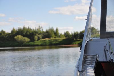 Cropped image of boat in lake against sky