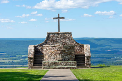 Built structure on field against sky