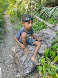 Portrait of boy sitting outdoors