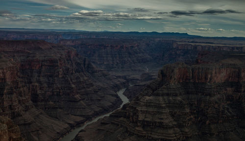 View of rock formations in cloudy sky