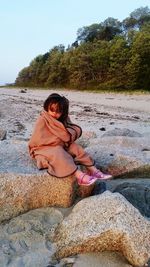 Portrait of young woman sitting outdoors