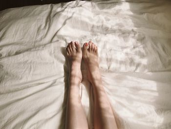 Low section of person legs on bed