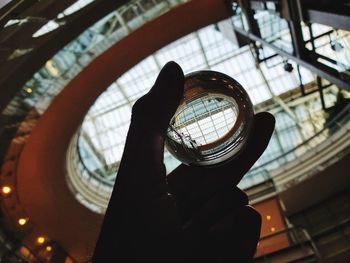 Low angle view of hand holding skylight