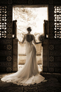 Rear view of bride standing in doorway