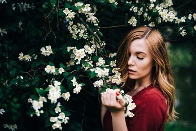 Beautiful young woman with flower tree