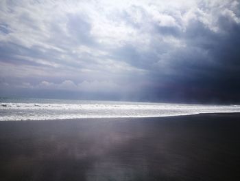 Scenic view of sea against cloudy sky