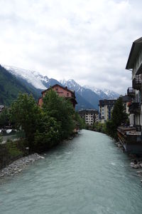 River amidst buildings against sky