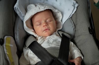 Portrait of newborn baby girl in baby stroller