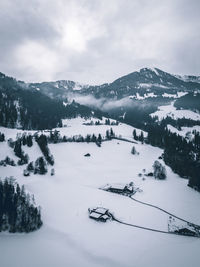 Scenic view of snow covered mountains against sky