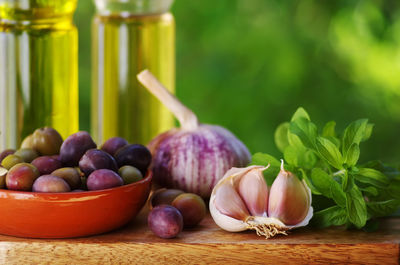 Close-up of olives and garlic on table