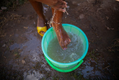 African woman washing her hands, covid-19 measures, corona virus conditions 