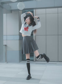 Portrait of young woman standing in gym