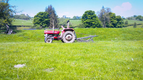 Tractor on field against sky