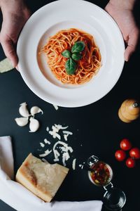 High angle view of person holding food on table