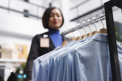 Portrait of young woman standing in store