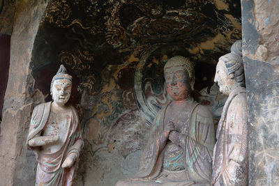 Sculpture of buddha statue outside historic building