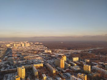 High angle view of buildings in city during sunset