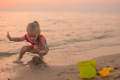 Full length of girl on beach during sunset