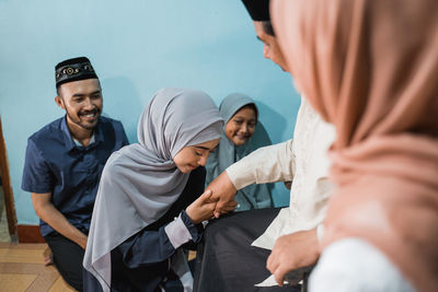 Low angle view of young woman holding hands