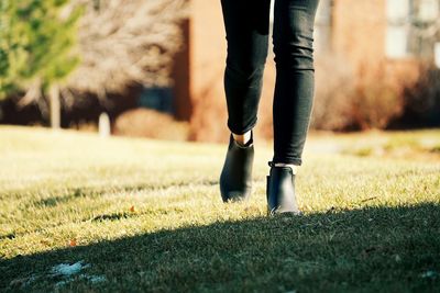 Low section of woman standing on grass