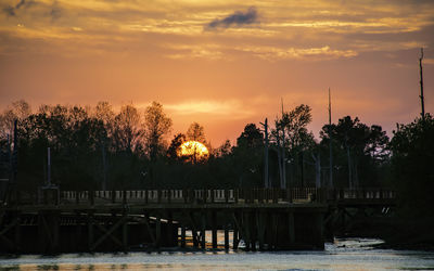 Scenic view of lake against orange sky